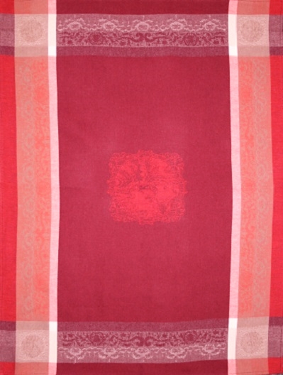 A dark red tea towel with pink patterns