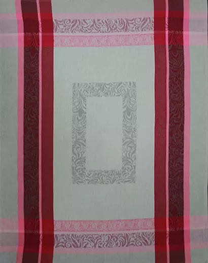 A white tea towel with red and pink patterns