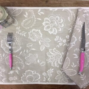 A grey placemat with a knife and fork