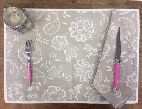 A grey placemat with a knife and fork