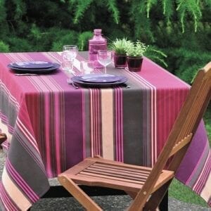 A pink table cloth with utensils and potted plants