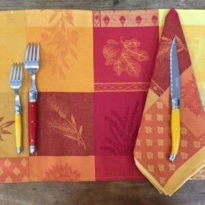 A placemat with red and orange patches