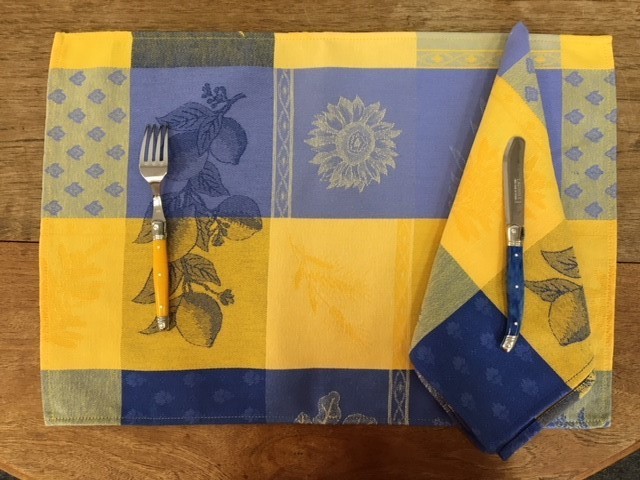 A placemat with blue and yellow patches