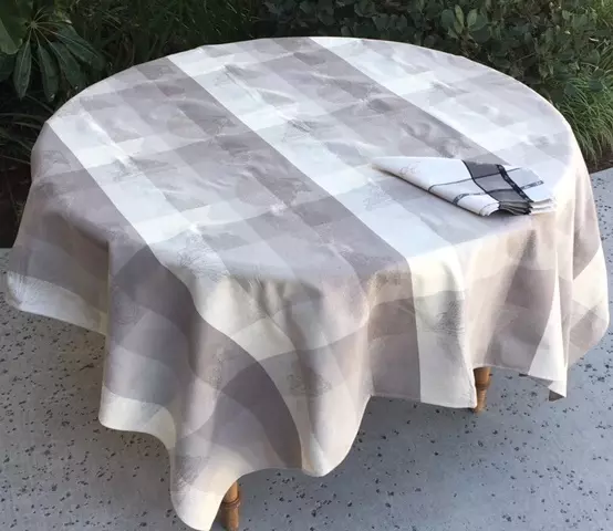 A grey and white table cloth with checkered patterns