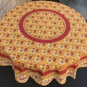 A yellow table cloth with leaf-like patterns