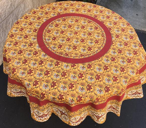 A yellow table cloth with leaf-like patterns