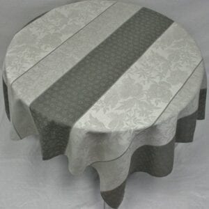 A white and dark grey table cloth with patterns