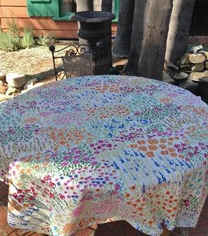 A white table cloth with colorful patterns